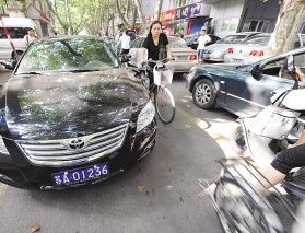 这位女主任驾驶的公车，公然违停在路边。 吴俊 摄